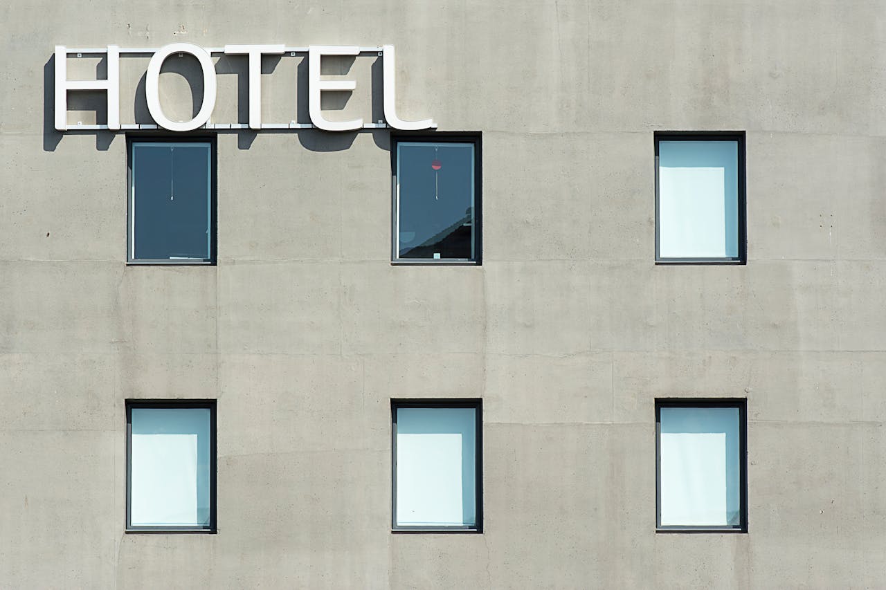 featured-portfolio-05 Contemporary hotel facade featuring minimalist design and geometric window patterns.