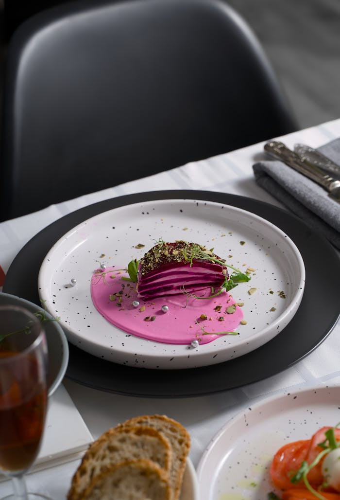 featured-portfolio-02 A gourmet beet dish elegantly plated with vibrant pink sauce and garnishes, ideal for culinary presentations.